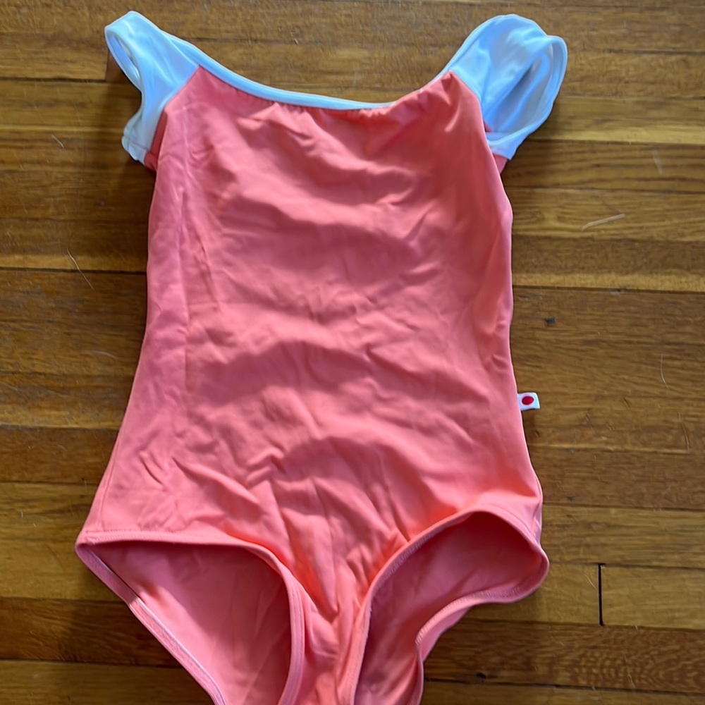 Peach yumiko leotard with white cap sleeves. size extra small